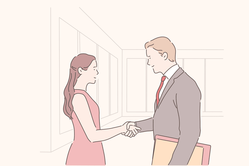 A woman and man shaking hands in a business transaction.